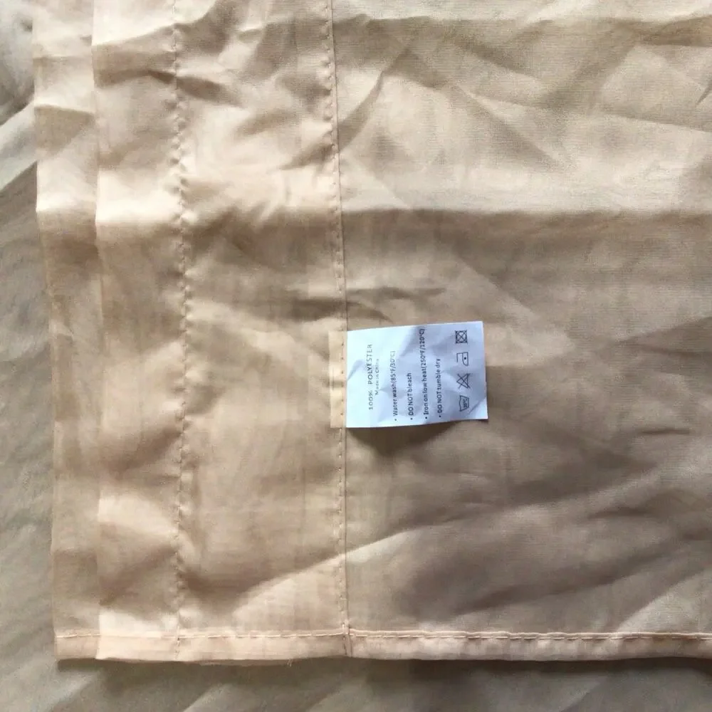 Two sheer terra-cotta rod pocket curtain panels